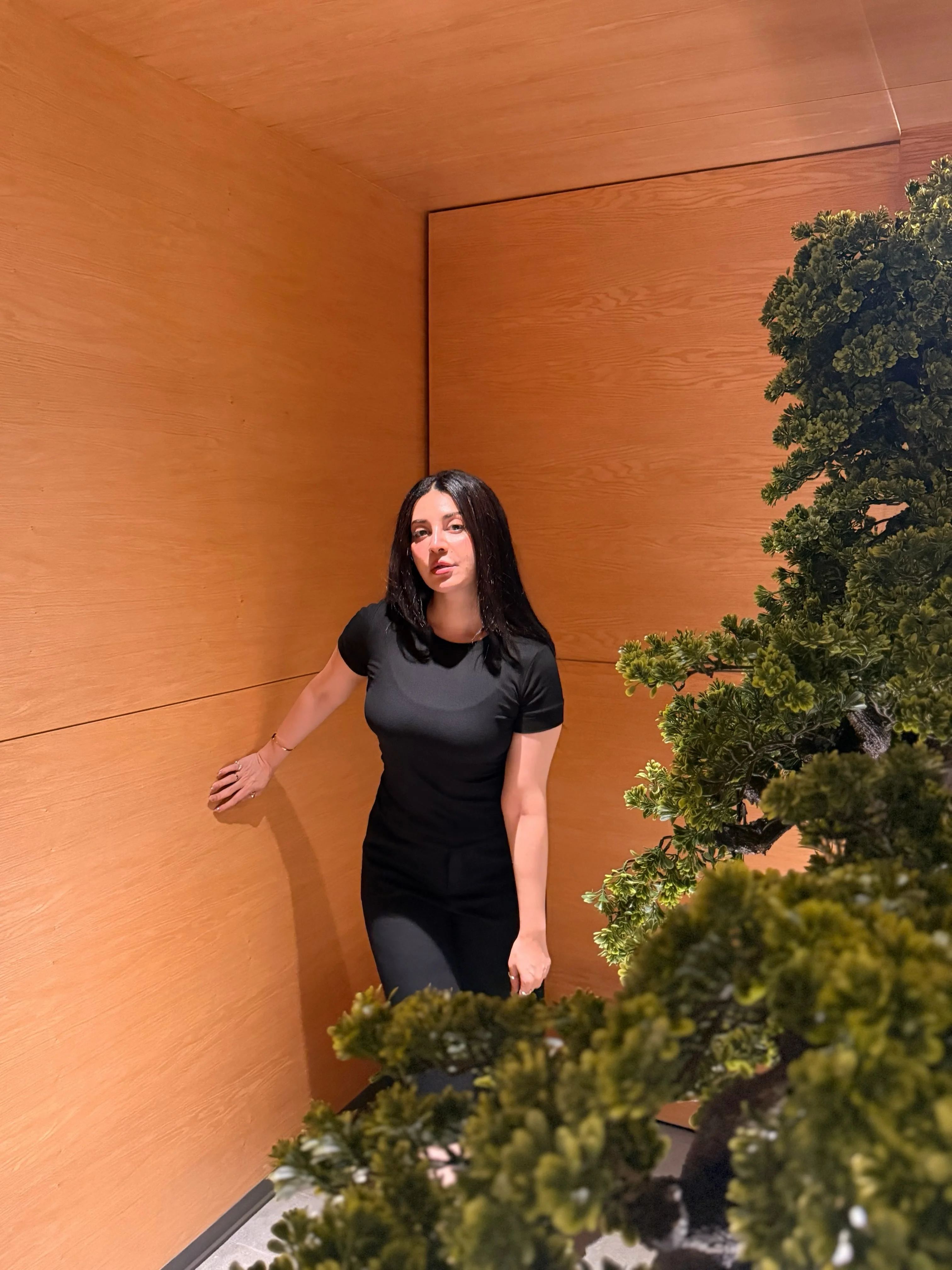 Neha Khan wearing black in an outdoor portrait